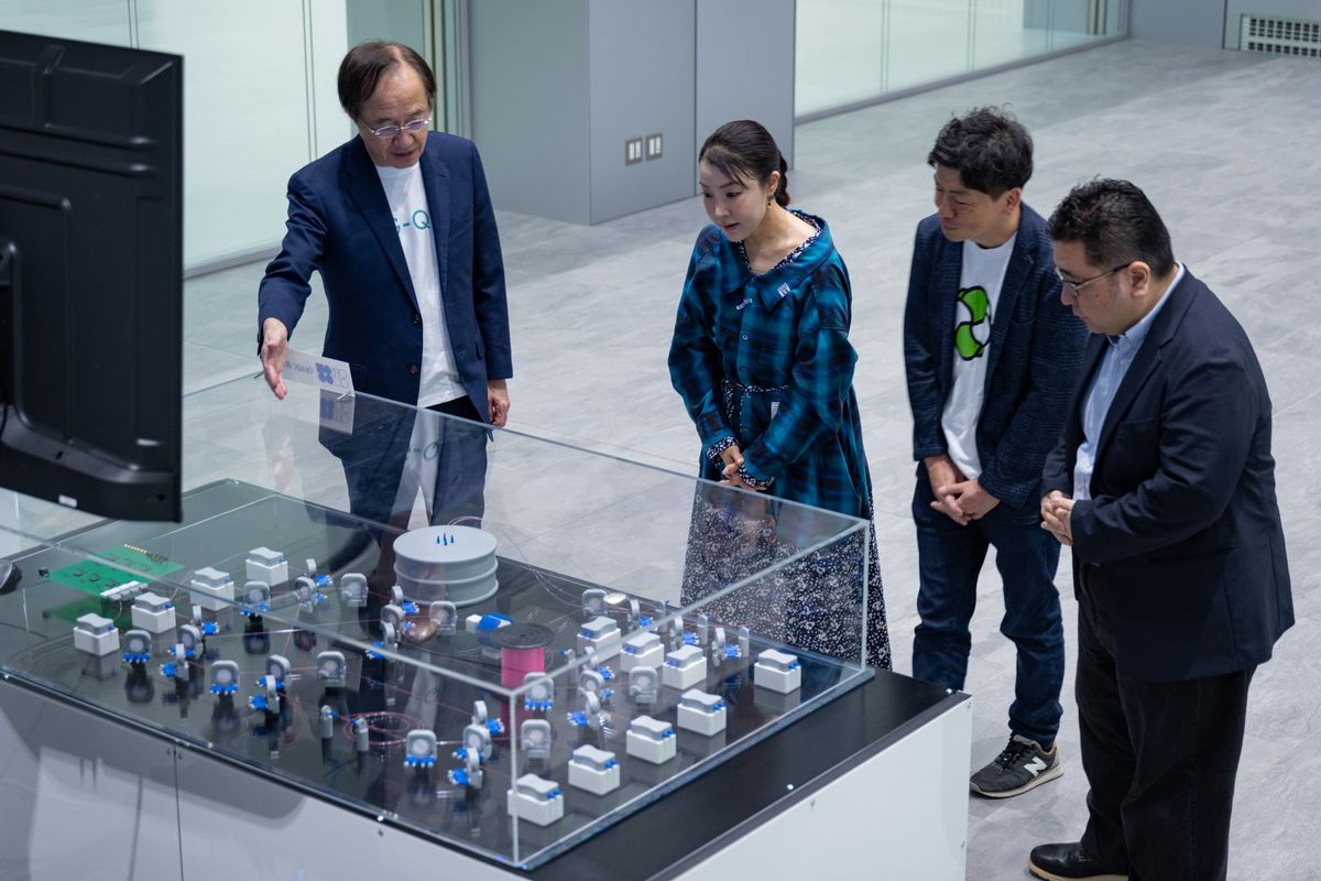 2023年7月に発足した研究センター「G-QuAT（Global Research and Development Center for Business by Quantum-AI Technology）」に導入予定の光量子コンピュータについてモックで説明する益。写真右は、未踏ターゲット事業PMの田中宗、その隣は、デロイトトーマツ グループ 量子技術統括の寺部雅能。